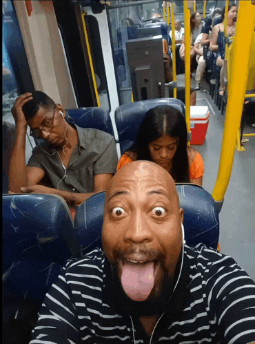 a man making a funny face on a bus