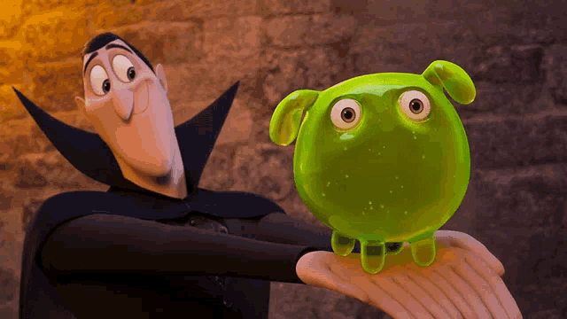 a cartoon character in a black cape holds a green frog with big eyes