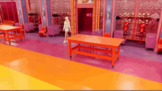 a woman in a white dress is standing in a room with a table and chairs .