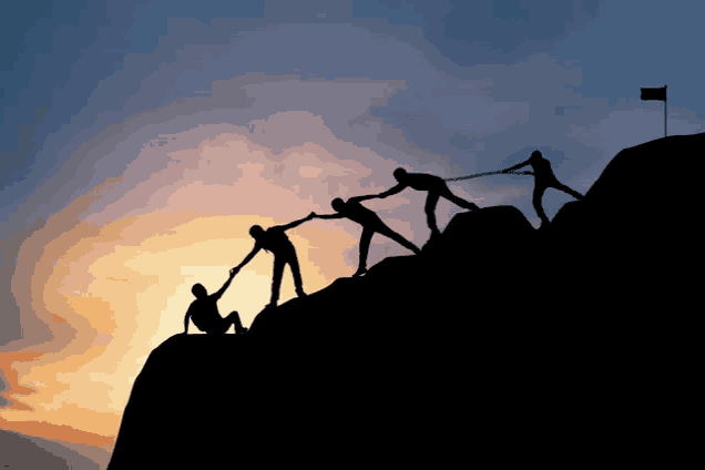 a group of people are helping each other up a mountain