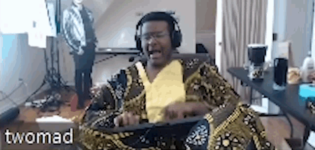 a man wearing headphones is sitting in a chair in a living room .