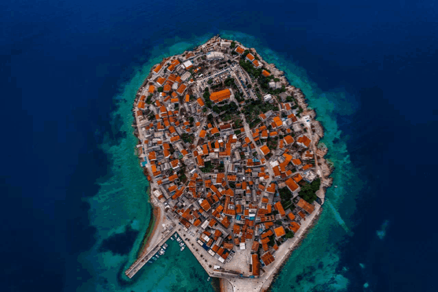 an aerial view of a small island with houses on it