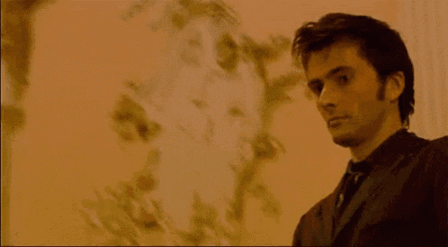 a man is smiling with the words deal with it behind him