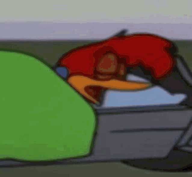 woody woodpecker is sleeping in a bed with a green blanket on it .