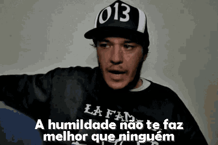 a man wearing a hat with the number 013 on it .