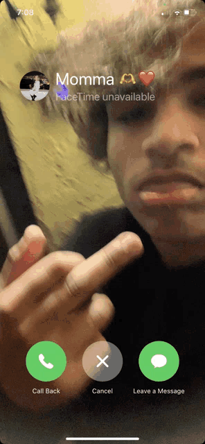 a phone screen shows a man giving the middle finger while talking to momma