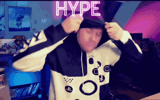 a man wearing a black and white hoodie with the word hype above him