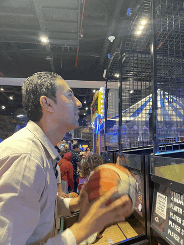 a man playing a basketball game with a sign that says player 2 player 3 and player 4