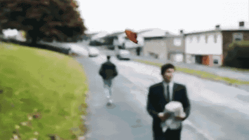 a blurry picture of a man in a suit holding a dog