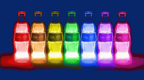 a row of coca cola bottles are lit up in rainbow colors
