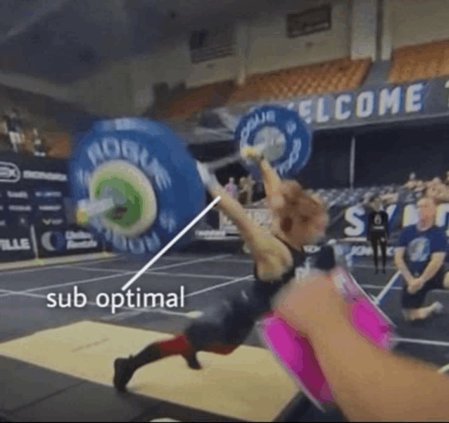 a woman lifts a barbell in front of a sign that says rogue