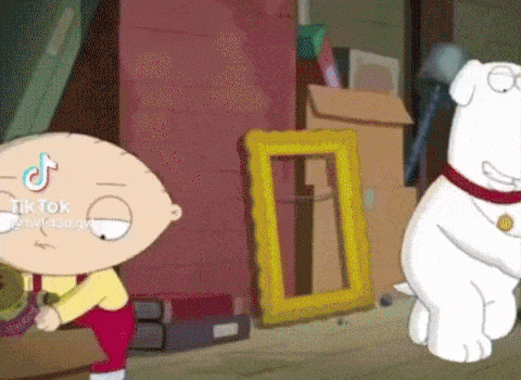 stewie from family guy is standing next to a dog in a room .