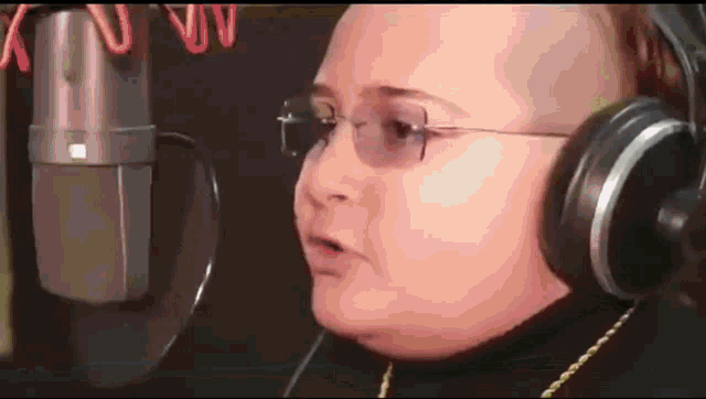 a person wearing headphones is singing into a mic