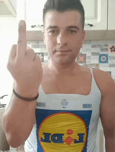 a man wearing a lidl shirt is giving the middle finger