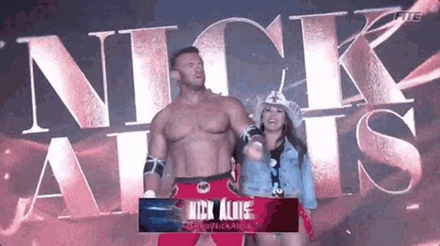a man and a woman are standing next to each other in front of the word nick allis