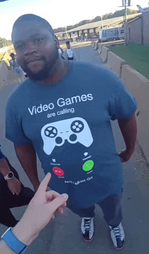 a man wears a shirt that says video games are calling