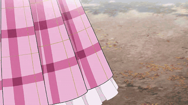 a girl in a pink plaid dress is standing on a dirt road