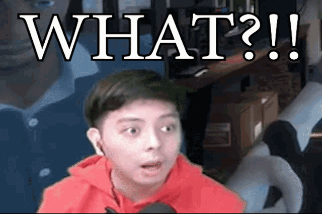 a man in a red hoodie says what in front of another man
