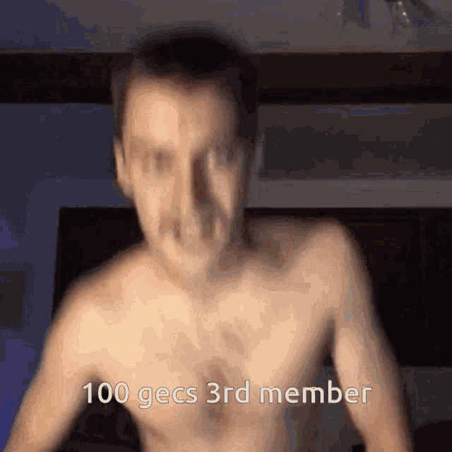 a shirtless man is dancing with the words 100 gecs 3rd member below him
