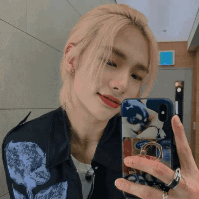 a young man taking a selfie with a phone case that says ' abercrombie & fitch ' on it