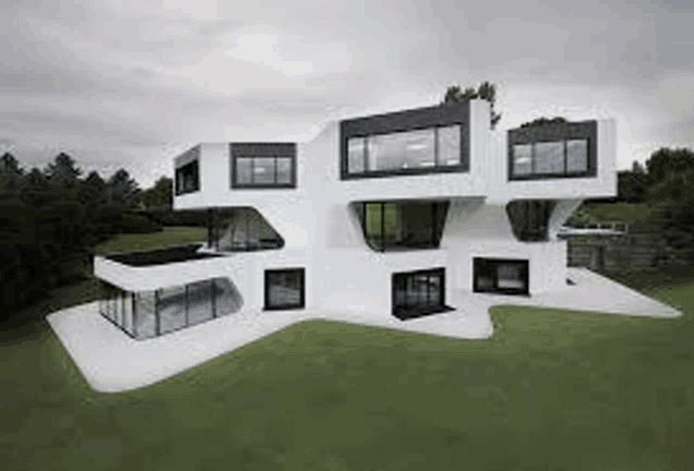 a large white house with a lot of windows is sitting on top of a lush green field .