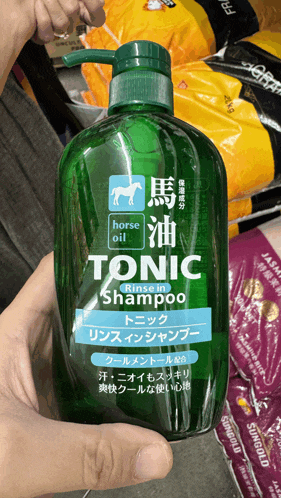 a bottle of tonic shampoo with horse oil in it