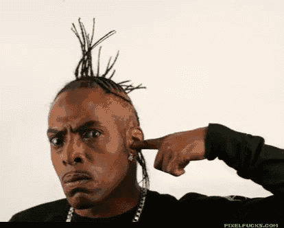 a man with dreadlocks covering his ears with his hand