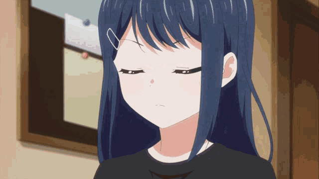 a girl with blue hair and a black shirt is looking down