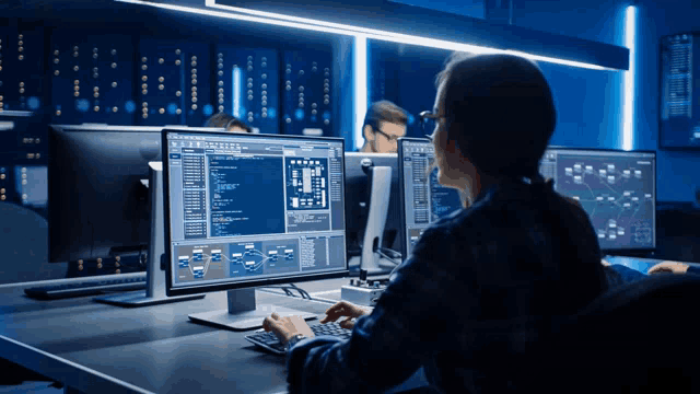 a woman is typing on a keyboard in front of a dell computer monitor