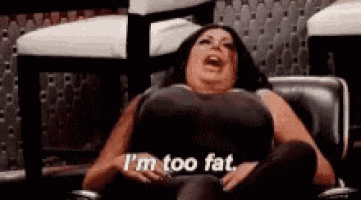 a woman is sitting in a chair with her legs crossed and says `` i 'm too fat '' .