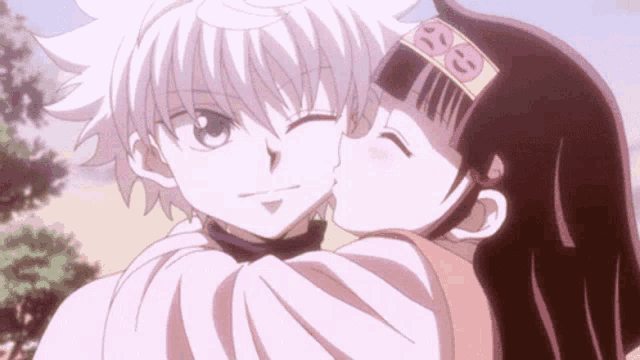 a girl is kissing a boy on the cheek in an anime scene