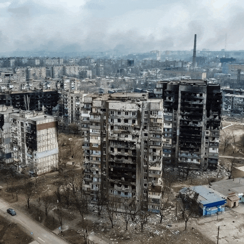 an aerial view of a city with a few buildings that have been damaged