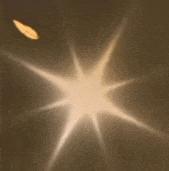 a glowing star with a leaf in the foreground on a brown background .