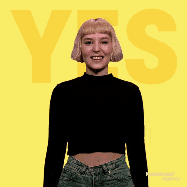a woman is giving a thumbs up in front of a yellow background that says yes