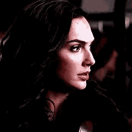 a close up of a woman 's face with a serious expression .