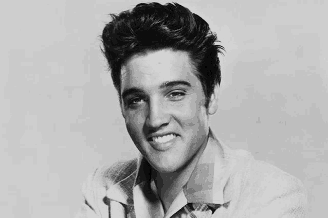 elvis presley is smiling in this black and white photo