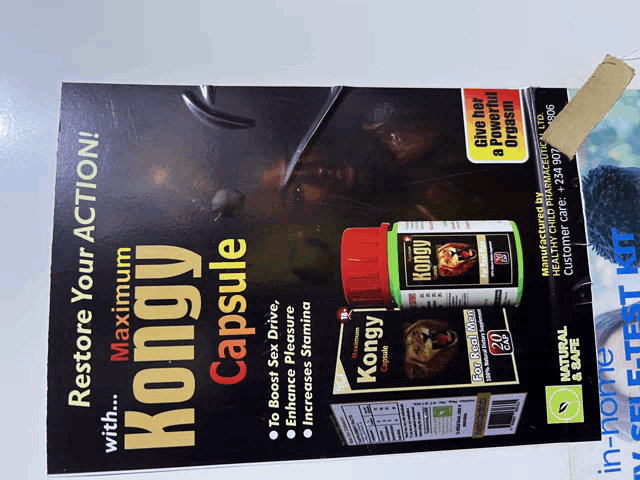 a bottle of kongy capsules sits on top of a poster that says restore your action