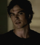 a man in a black shirt is looking at the camera .