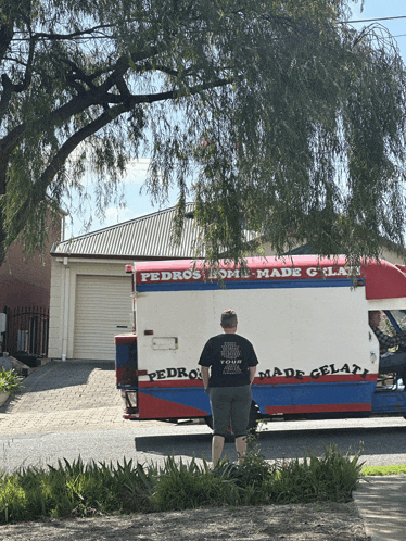 a man stands in front of a pedro 's homemade gelato truck