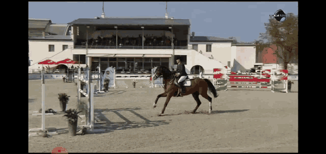 a person riding a horse in front of a building with a sign on it that says ' a ' on it