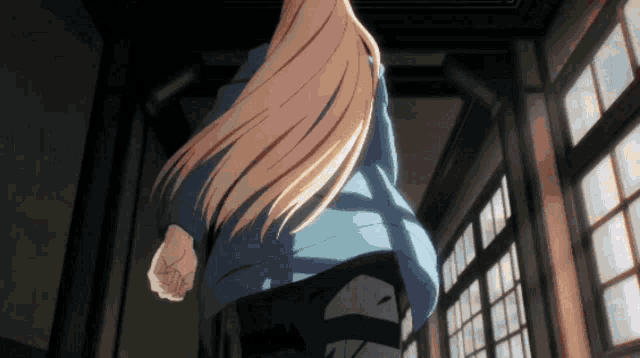a woman with long blonde hair walking down a hallway
