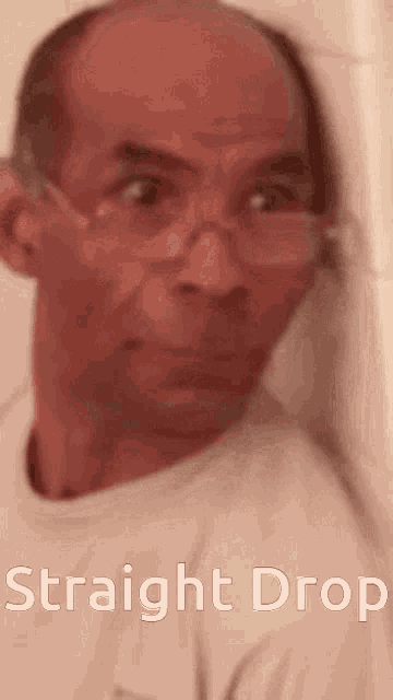 a man wearing glasses and a white shirt with the words straight drop written below him