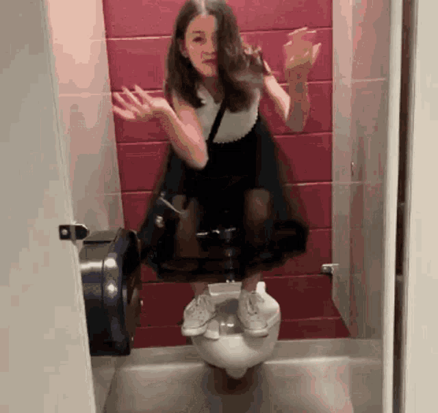 a girl in a dress is sitting on a toilet