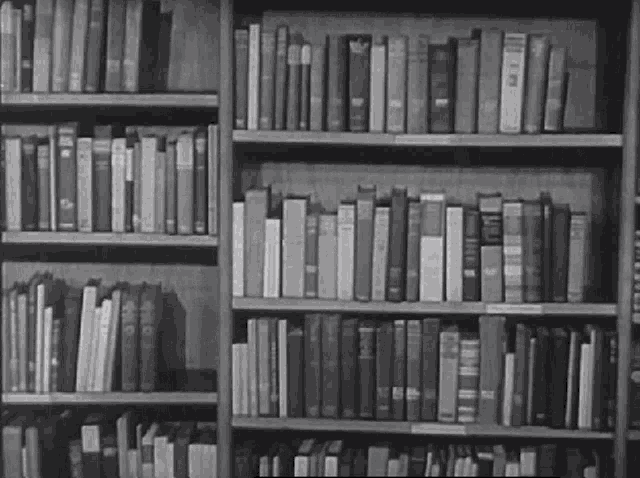 a black and white photo of a bookshelf filled with books including one that says ' i 'm ' on it