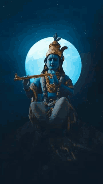 a statue of a blue krishna playing a flute in front of a full moon .