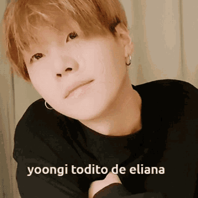 a close up of a person with the words yoongi todito de eliana below them