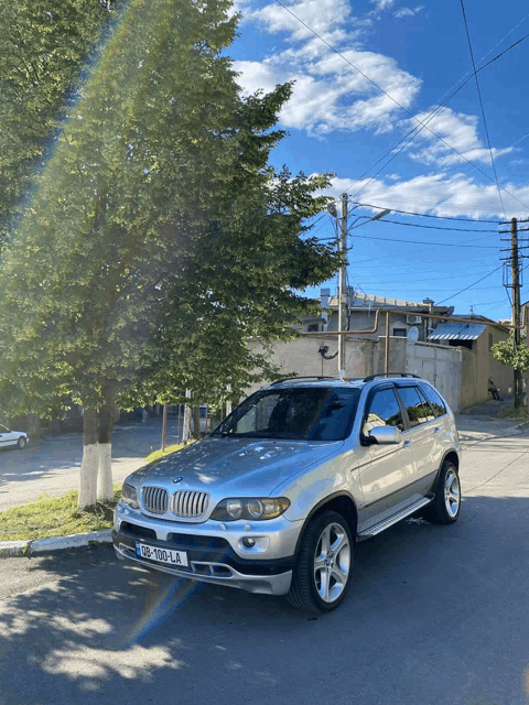 a silver bmw with a license plate that says gp 102 la