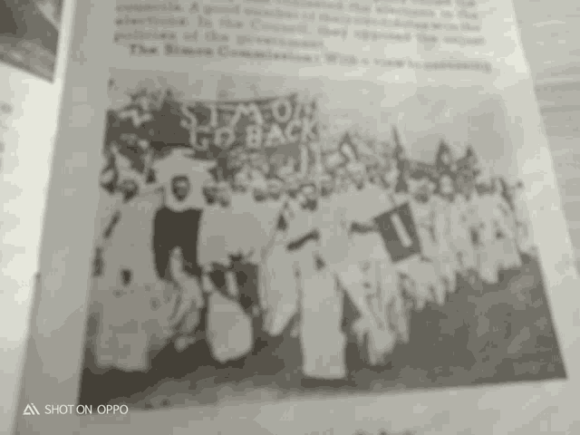 a black and white photo of a group of people standing in a line .