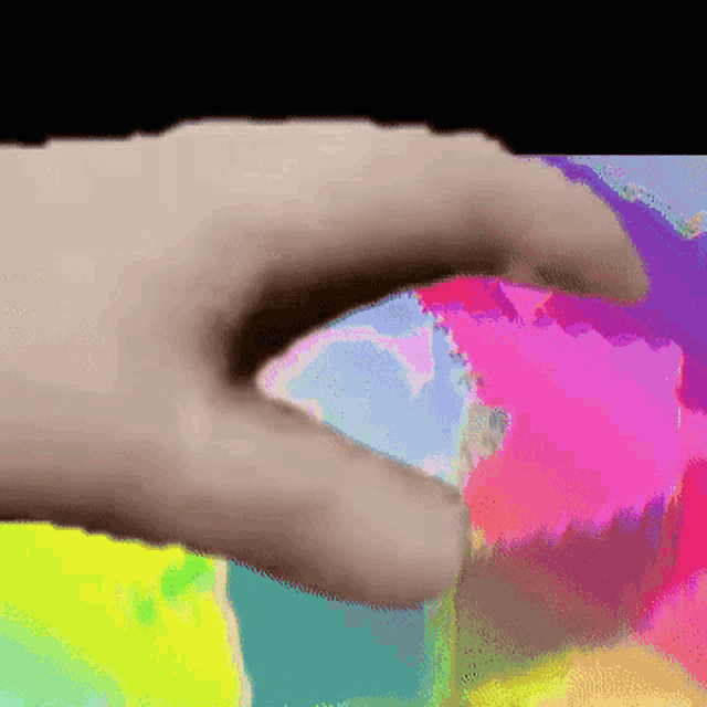 a close up of a person 's hand with a colorful background