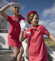 two women in pink uniforms are standing on stairs